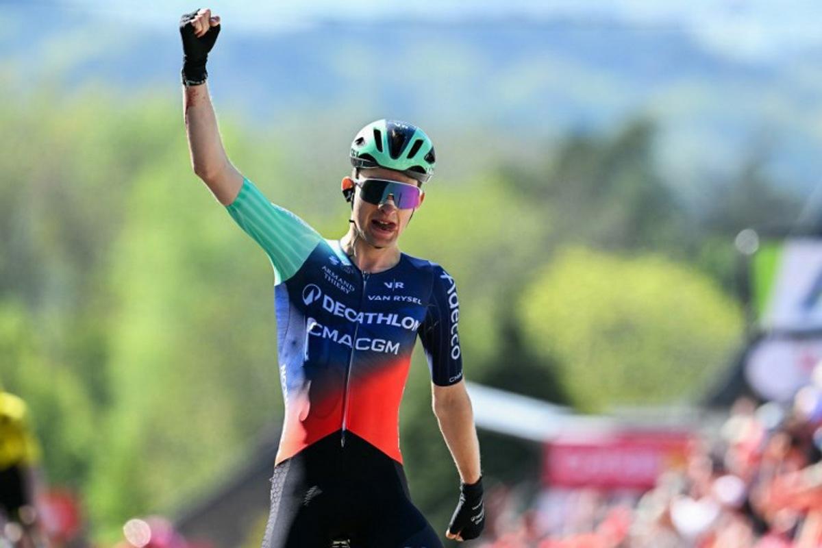 Decathlon CMA CGM Team's French Paul Seixas celebrates as he crosses the finish line to win 'La Fleche Wallonne' one day cycling race, 200 km from Herstal to Huy, on April 22, 2026.  JOHN THYS / AFP