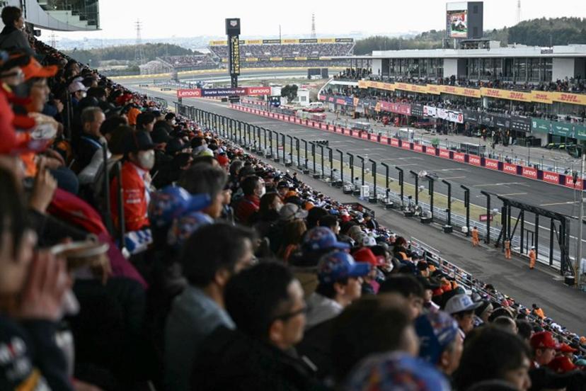 Fans watch Ferrari's British driver Lewis Hamilton drives during the Formula One Japanese Grand Prix at the Suzuka circuit in Suzuka, Mie prefecture, Japan on April 6, 2025.  MOHD RASFAN / AFP