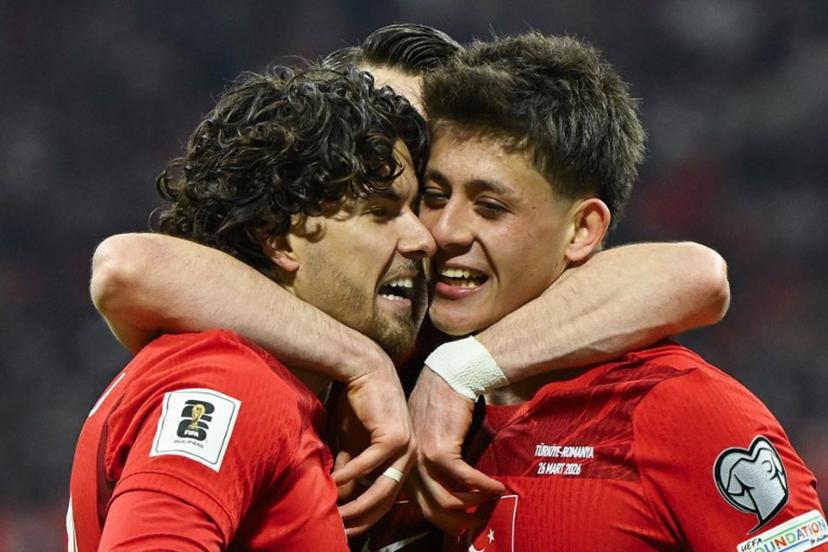 Turkey's defender #20 Ferdi Kadioglu (L) celebrates with Turkey's midfielder #08 Arda Guler (R) after scoring his team first goal during the play-off FIFA World Cup 2026 European qualification knockout semi-final football match between Turkey and Romania at Besiktas Park stadium, in Istanbul on March 26, 2026.  YASIN AKGUL / AFP