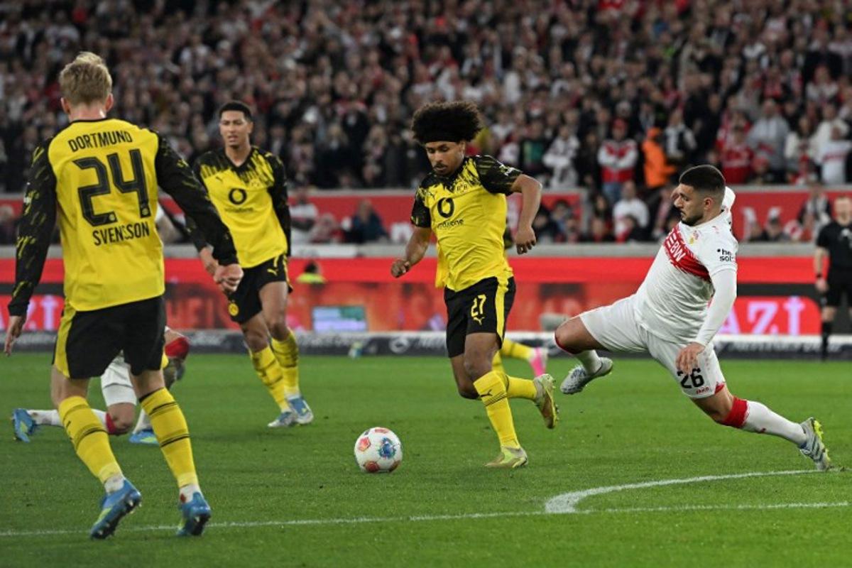 Stuttgart's German forward #26 Deniz Undav (R) and Dortmund's German forward #27 Karim Adeyemi vie for the ball during the German first division Bundesliga football match between VfB Stuttgart and BVB Borussia Dortmund in Stuttgart, southern Germany, on April 4, 2026.  THOMAS KIENZLE / AFP