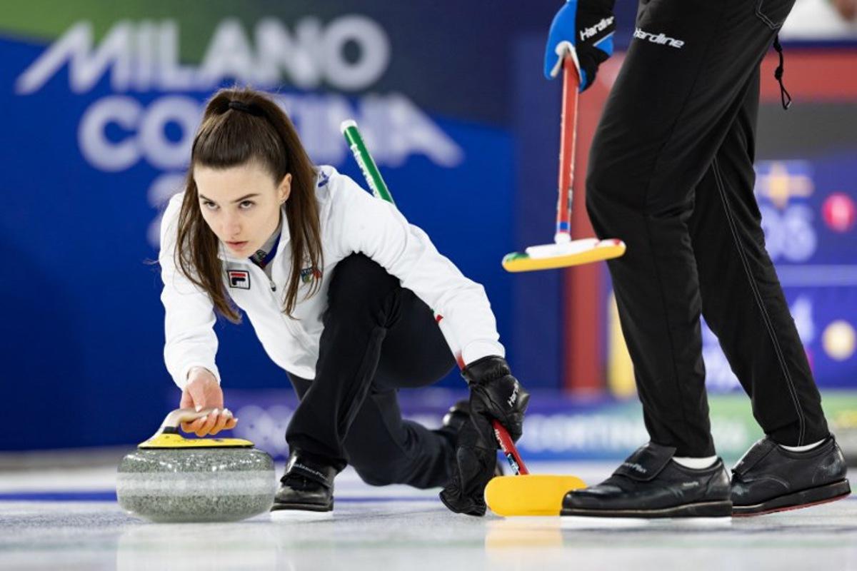 Italy's Stefania Constantini (L) competes in the curling mixed doubles round robin between Sweden and Italy during the Milano Cortina 2026 Winter Olympic Games at the Cortina Curling Olympic Stadium in Cortina d'Ampezzo on February 7, 2026.  Odd ANDERSEN / AFP