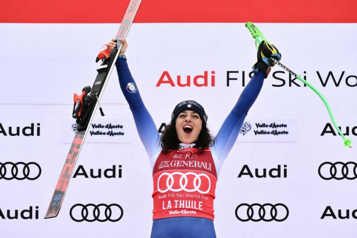 Italy's Federica Brignone celebrates on the podium of the Women's Super G replacing St Moritz event of FIS Alpine Skiing World Cup in La Thuile, Italy on March 14, 2025. Italy's Federica Brignone won the race ahead of Italy's Sofia Goggia and France's Romane Miradoli, third. A sensational run from Brignone gave her victory in the Italian alps by just 0.01sec over her compatriot Sofia Goggia. It extended her lead in the overall standings on Lara Gut-Behrami to 382 points.  Marco BERTORELLO / AFP