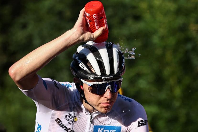 UAE Team Emirates' Slovenian rider Tadej Pogacar wearing the best young rider's white jersey douses himself with water to cool down as he cycles in the final ascent of Saint-Gervais-les-Bains in the last kilometers of the 15th stage of the 110th edition of the Tour de France cycling race, 179 km between Les Gets Les Portes du Soleil and Saint-Gervais Mont-Blanc, in the French Alps, on July 16, 2023.  Anne-Christine POUJOULAT / AFP