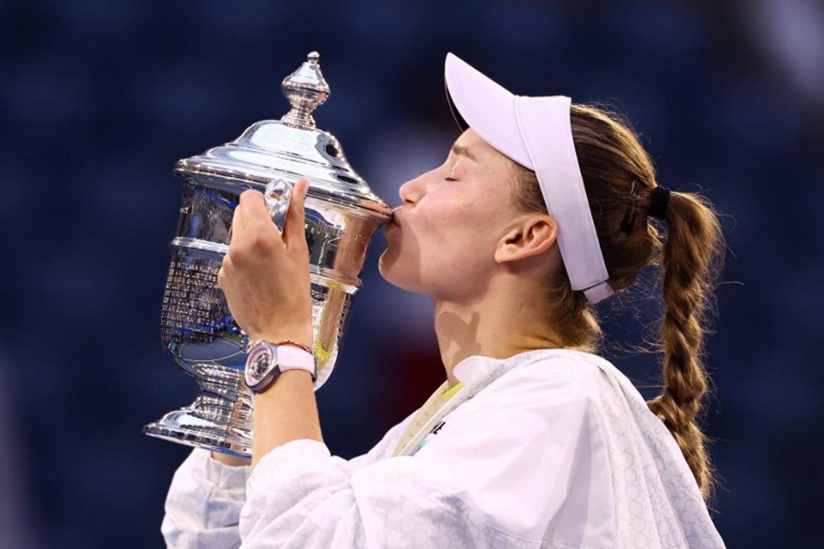 Kazakhstan's Elena Rybakina kisses the winner's trophy after winning the women's singles final tennis match against Belarus's Aryna Sabalenka on day fourteen of the US Open tennis tournament at the USTA Billie Jean King National Tennis Center in New York City on September 12, 2026.  CHARLY TRIBALLEAU / AFP