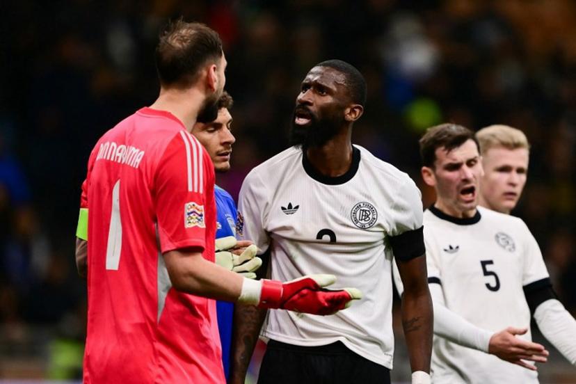 Italy's goalkeeper #01 Gianluigi Donnarumma argues with Germany's defender #02 Antonio Rudiger during the Nations League quarter final first leg football match between Italy and Germany at the San Siro Stadium in Milan, on March 20, 2025.  Marco BERTORELLO / AFP
