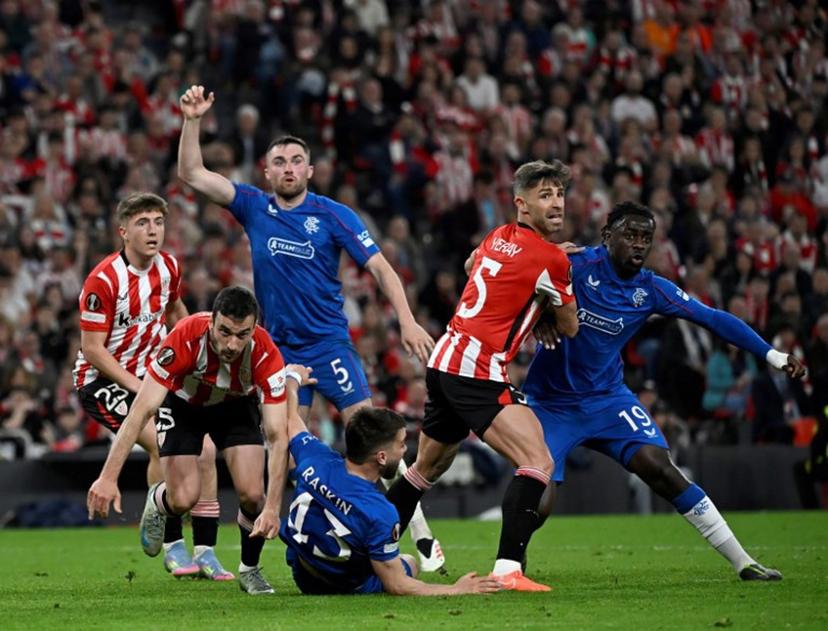 Athletic Bilbao's Spanish defender #05 Yerai Alvarez and Rangers' French defender #19 Clinton Nsiala eye the ball during the UEFA Europa League quarter final second leg football match between Athletic Club Bilbao and Glasgow Rangers, at the San Mames stadium in Bilbao on April 17, 2025.  ANDER GILLENEA / AFP