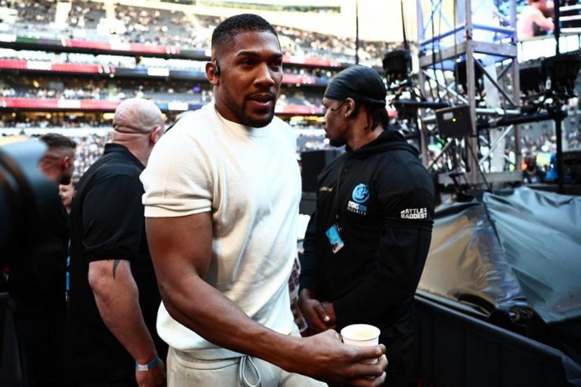 British boxer Anthony Joshua is seen ringside ahead of the heavyweight fight between Britain's Tyson Fury and Russia's Arslanbek Makhmudov at the Tottenham Hotspur stadium in London on April 11, 2026.  Henry NICHOLLS / AFP