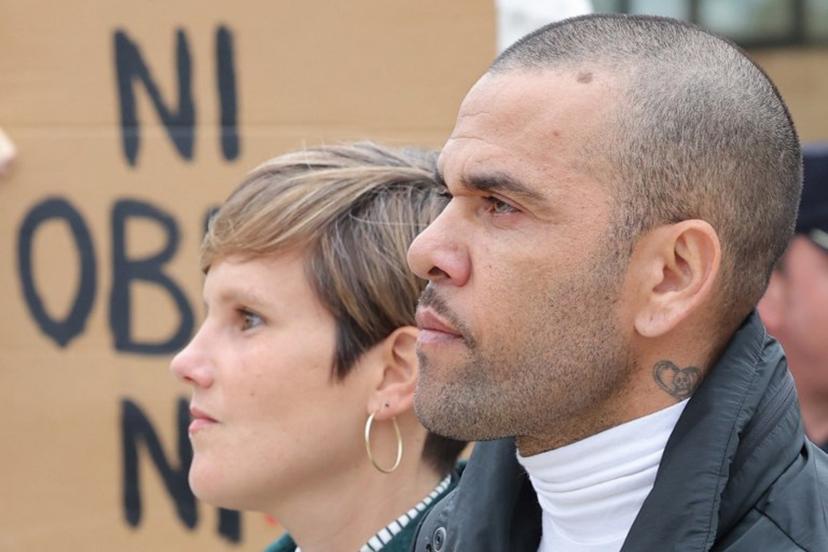 Prison workers unions' members protest over the killing of a cook by an inmate the week before, as convicted rapist and former Brazil international football player Dani Alves (R), flanked by his lawyer Ines Guardiola, leaves Brians 2 prison in San Esteban Sasroviras, near Barcelona, on March 25, 2024. Convicted rapist and former Brazil international Dani Alves left a jail in Barcelona on March 25, 2024 after posting the one-million-euro bail set by a Barcelona court to ensure his release pending appeal. Ex-Brazil star has been sentenced to 4.5 years in jail for rape on February 22, 2024. LLUIS GENE / AFP