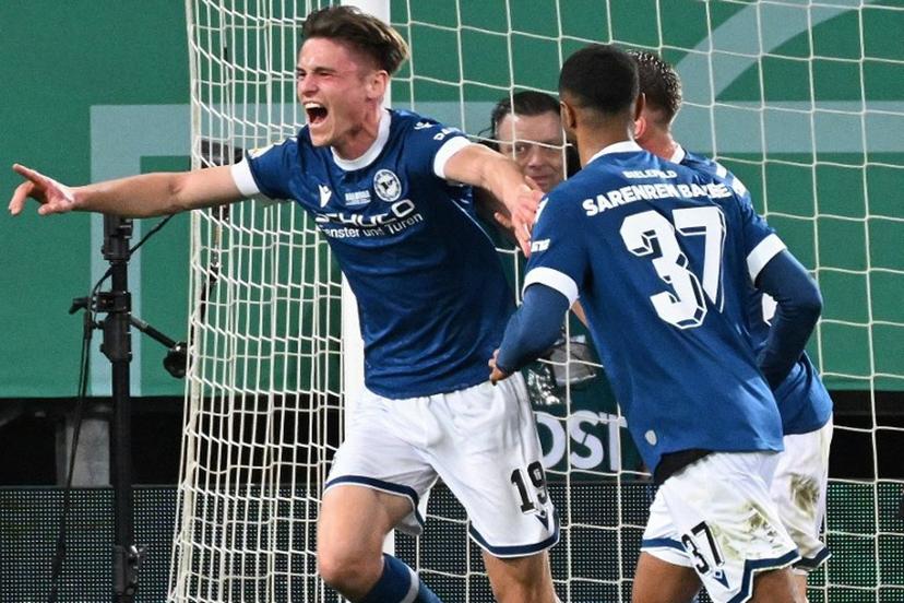 Arminia Bielefeld's German defender #19 Maximilian Grosser (L) celebrates scoring the 2-1 goal with his teammates during the German Cup (DFB Pokal) semi-final football match between Arminia Bielefeld and Bayer 04 Leverkusen in Bielefeld, western Germany on April 1, 2025.  UWE KRAFT / AFP