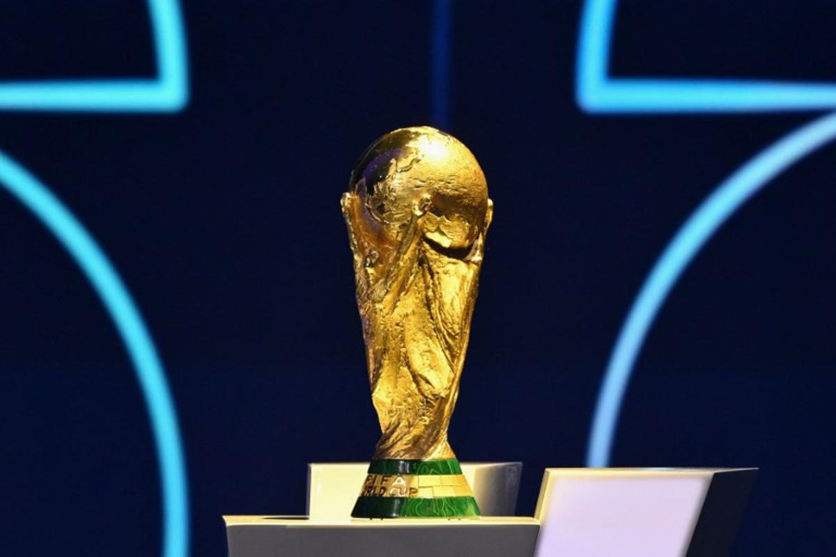 The FIFA World Cup Trophy is displayed on a podium during the draw for the 2026 FIFA Football World Cup taking place in the US, Canada and Mexico, at the Kennedy Center, in Washington, DC, on December 5, 2025.  Mandel NGAN / POOL / AFP