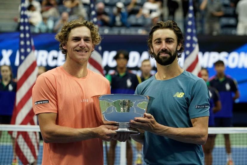 (L-R) Australia's Max Purcell and Jordan Thompson hold the trophy after defeating Germany's Tim Puetz and Kevin Krawietz in their men's doubles final match on day thirteen of the US Open tennis tournament at the USTA Billie Jean King National Tennis Center in New York City, on September 7, 2024.  TIMOTHY A. CLARY / AFP