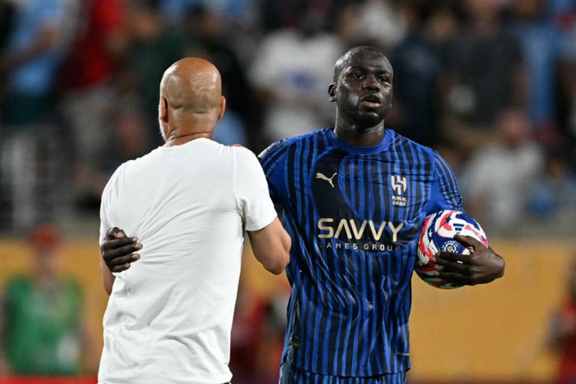 Al Hilal's Senegalese defender #03 Kalidou Koulibaly grabs Manchester City's Spanish head coach Pep Guardiola during the FIFA Club World Cup 2025 round of 16 football match between England's Manchester City and Saudi's Al-Hilal at the Camping World stadium in Orlando on June 30, 2025.  PATRICIA DE MELO MOREIRA / AFP