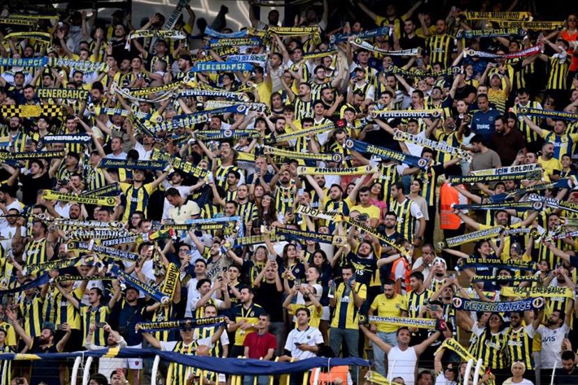 Fenerbahce's fans cheer during the UEFA Champions League 3rd Qualifying Round second leg football match between Fenerbahce and Lille LOSC at the Fenerbahçe Sükrü Saracoğlu Stadium in Istanbul on August 13, 2024.  Ozan KOSE / AFP