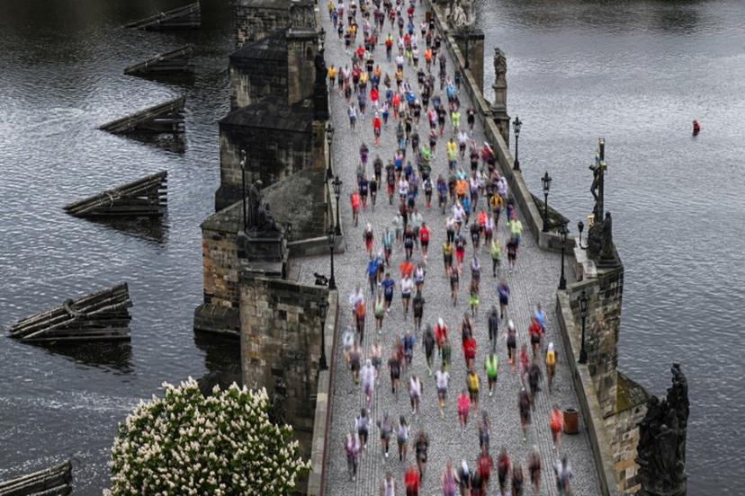 Participants run across the Charles Bridge as they take part in the Prague's international marathon on May 4, 2025 in Prague, Czech Republic.   Michal Cizek / AFP