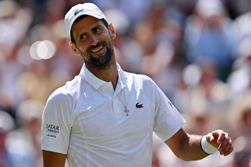 Serbia's Novak Djokovic smiles as he plays against France's Arthur Rinderknech during their men's singles third round tennis match on the fifth day of the 2026 Wimbledon Championships at The All England Lawn Tennis and Croquet Club in Wimbledon, southwest London, on July 3, 2026.  Glyn KIRK / AFP