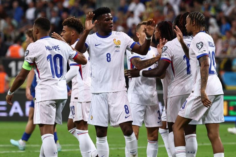 France's forward #11 Michael Olise celebrates with his team mates after scoring his team's first goal during the 2026 World Cup qualifiers Europe zone group D football match between Ukraine and France, on September 5, 2025 in Wroclaw, Poland.  FRANCK FIFE / AFP