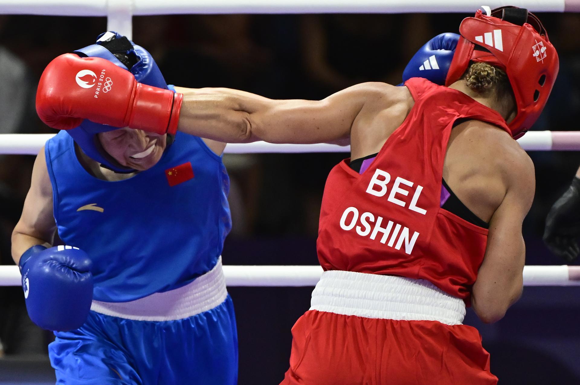 Belgian boxer Oshin Derieuw (red) and Chinese boxer Liu Yang (blue) pictured in action during a boxing bout between Belgian Derieuw and Chinese Yang, in the quarterfinal of the women's -66kg category at the Paris 2024 Olympic Games, on Saturday 03 August 2024 in Paris, France. The Games of the XXXIII Olympiad are taking place in Paris from 26 July to 11 August. The Belgian delegation counts 165 athletes competing in 21 sports. BELGA PHOTO DIRK WAEM