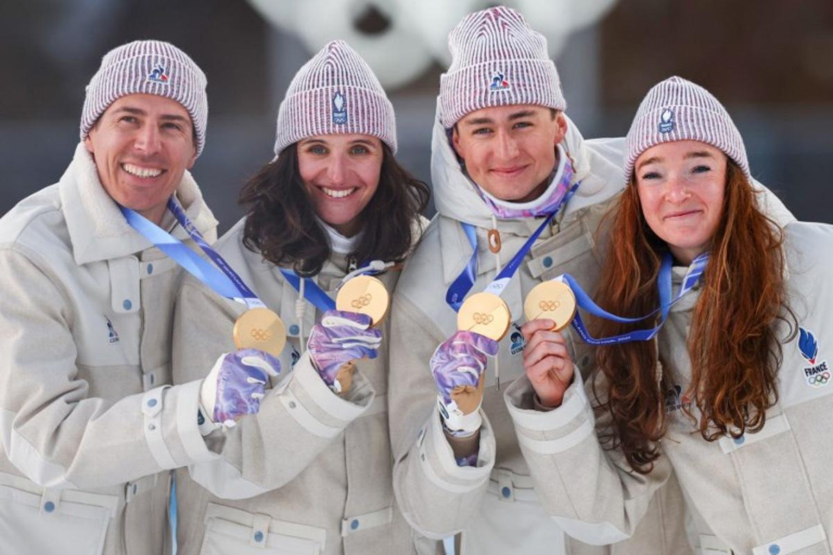 Gold medallists France's Eric Perrot, France's Quentin Fillon Maillet, France's Lou Jeanmonnot, France's Julia Simon pose with their medals on the podium of the mixed biathlon 4 x 6km relay event during the Milano Cortina 2026 Winter Olympic Games at the Anterselva Biathlon Arena (Sudtirol Arena) in Anterselva (Val Pusteria) on February 8, 2026.  FRANCK FIFE / AFP