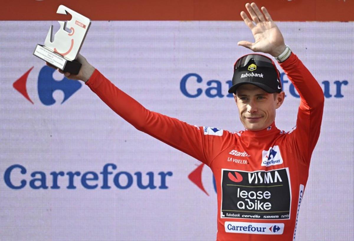 The overall leader Team Visma-Lease a bike's Danish rider Jonas Vingegaard celebrates on the podium wearing the red jersey after the tenth stage of the Vuelta a Espana cycling tour, a 168 km race between Sendaviva Natural Park in Arguedas and El Ferial Larra Belagua in Isaba, on September 2, 2025.    Ander GILLENEA / AFP