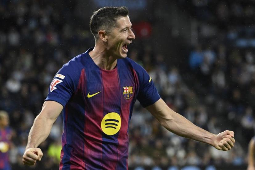 Barcelona's Polish forward #09 Robert Lewandowski celebrates his second goal during the Spanish league football match between RC Celta de Vigo and FC Barcelona at Balaidos Stadium in Vigo on November 9, 2025.  Miguel RIOPA / AFP