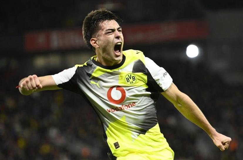 Dortmund's Argentinian defender #28 Aaron Anselmino celebrates his 0-1 during the German first division Bundesliga football match between Bayer 04 Leverkusen and Borussia Dortmund in Leverkusen, western Germany, on November 29, 2025.  INA FASSBENDER / AFP