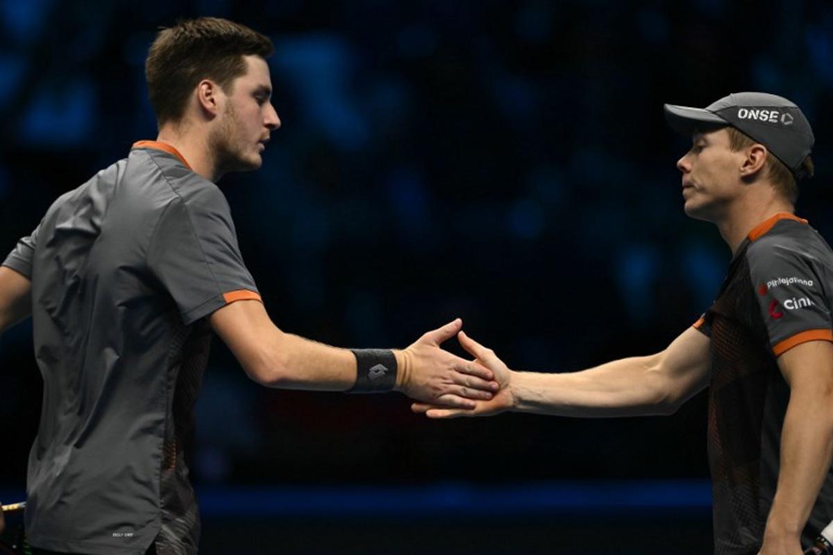 British Henry Patten and Finnish Harri Heliovaara celebrate celebrate a point against British Joe Salisbury and British Neal Skupski during the final of the double at the ATP Finals tennis tournament in Turin on November 16, 2025.  Marco BERTORELLO / AFP
