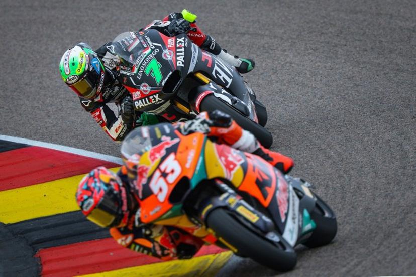Fantic Racing Team's Belgiums Moto2 rider Barry Baltus (background) steers his bike behind Red Bull KTM Ajo Team's Turkish Moto2 rider Deniz Oncu (front) during the German Moto2 Grand Prix at the Sachsenring racing circuit, in Hohenstein-Ernstthal near Chemnitz, eastern Germany on July 13, 2025.  Ronny Hartmann / AFP