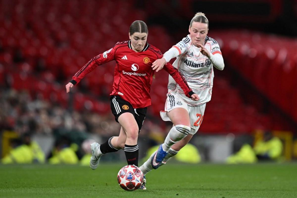 Manchester United's English forward #08 Jessica Park (L) and Bayern Munich's German forward #20 Franziska Kett (R) fight for the ball during the UEFA Women's Champions League, Quarter Final first-leg football match between Manchester United and Bayern Munich at Old Trafford in Manchester, north west England, on March 25, 2025.  Paul ELLIS / AFP