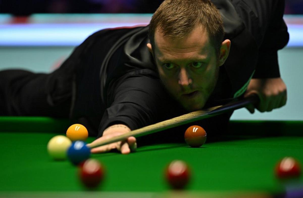 Northern Ireland's Mark Allen plays a shot during the snooker final of the 2022 Cazoo UK Championship at the York Barbican in York, on November 20, 2022. China's Ding Junhui faces Northern Ireland's Mark Allen in the final. Oli SCARFF / AFP