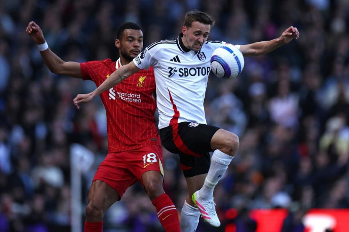 Liverpool's Dutch striker #18 Cody Gakpo (L) vies with Fulham's Belgian defender #21 Timothy Castagne (R) during the English Premier League football match between Fulham and Liverpool at Craven Cottage in London on April 6, 2025.  HENRY NICHOLLS / AFP