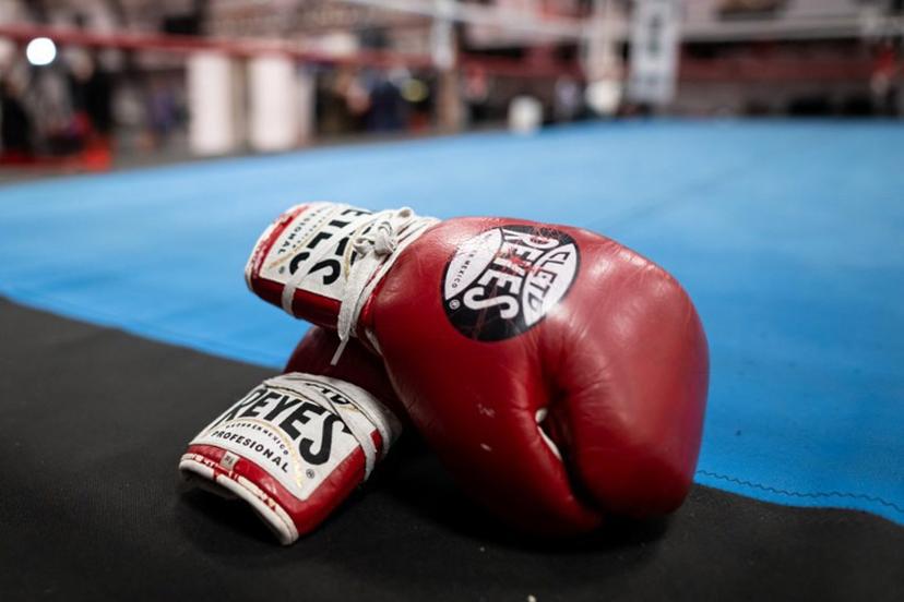 A pair of boxing gloves are seen at the sports and boxing hall at La Busserine neighbourhood in the northern Marseille on January 24, 2025.   In Marseille, former boxers put their experience to the service of young people from the northern neighbourhoods, confronted with violence and drug trafficking, hoping to "save a few". Miguel MEDINA / AFP
