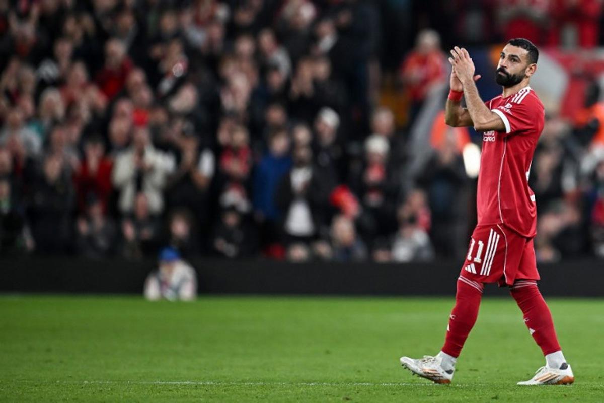 Liverpool's Egyptian forward #11 Mohamed Salah applauds as he leaves the pitch after being substituted during the UEFA Champions League, round of 16 second leg football match between Liverpool and Galatasaray at Anfield in Liverpool, north-west England on March 18, 2026.  Paul ELLIS / AFP