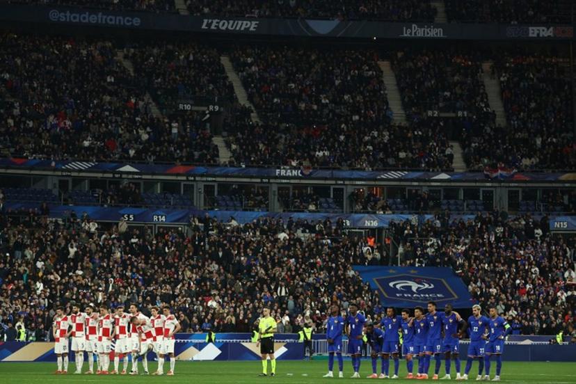 Croatia's players (L) and France's players (R) stand as they watch the penalty shoot-out during the UEFA Nations League quarter-final second-leg football match between France and Croatia at the Stade de France in Saint-Denis, north of Paris, on March 23, 2025.  FRANCK FIFE / AFP