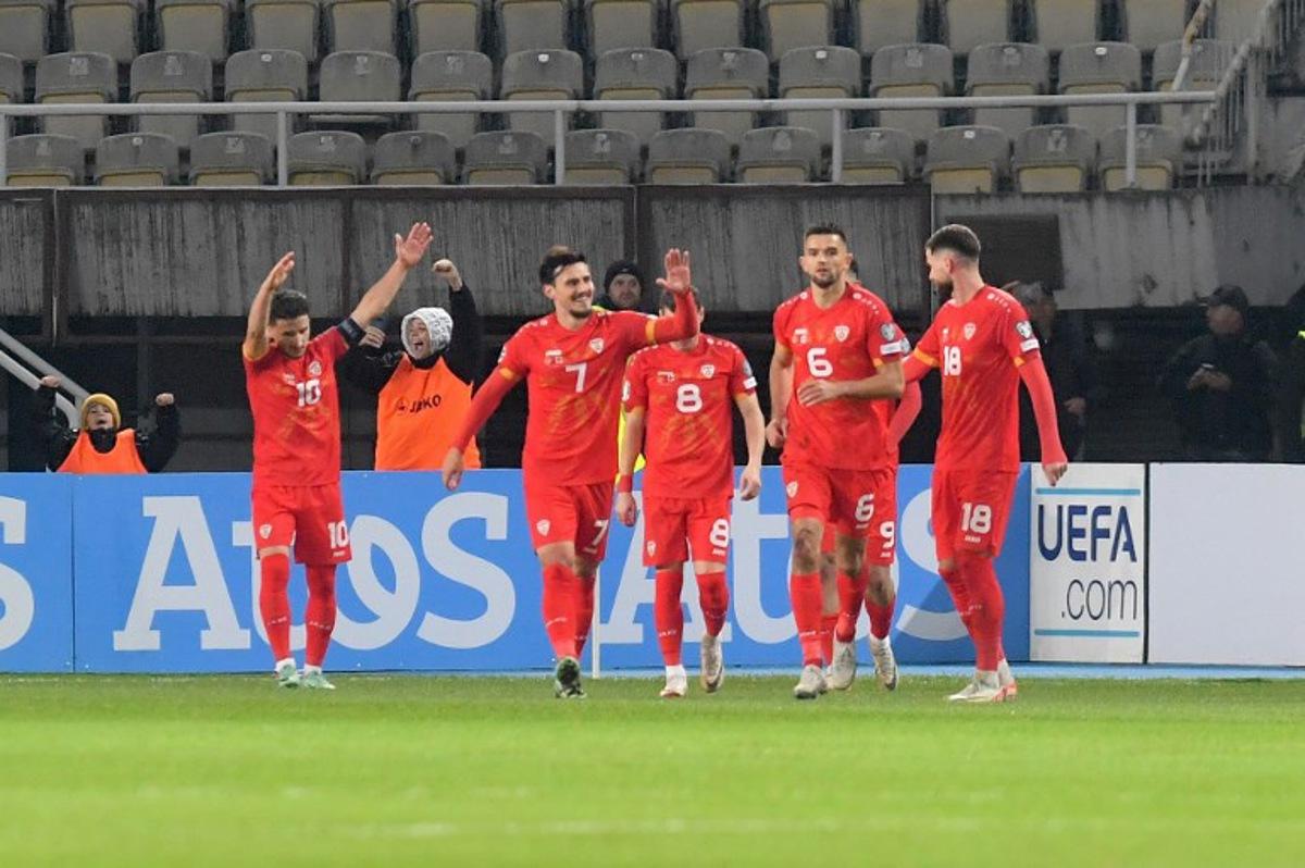 North Macedonia's midfielder #10 Enis Bardhi (L) celebrates with his teammates after scoring the opening goal during the UEFA Euro 2024 group C qualification football match between North Macedonia and England at National Arena "Todor Proeski" in Skopje on November 20, 2023.  Robert ATANASOVSKI / AFP