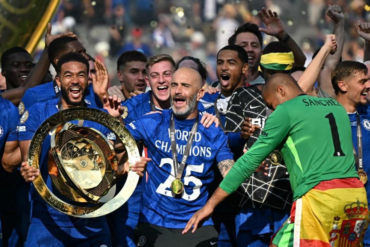 Chelsea's Italian head coach Enzo Maresca (C) celebrates with the trophy during the award ceremony for the FIFA Club World Cup 2025 Champions, following the final football match between England's Chelsea and France's Paris Saint-Germain at the MetLife Stadium in East Rutherford, New Jersey on July 13, 2025.  Paul ELLIS / AFP