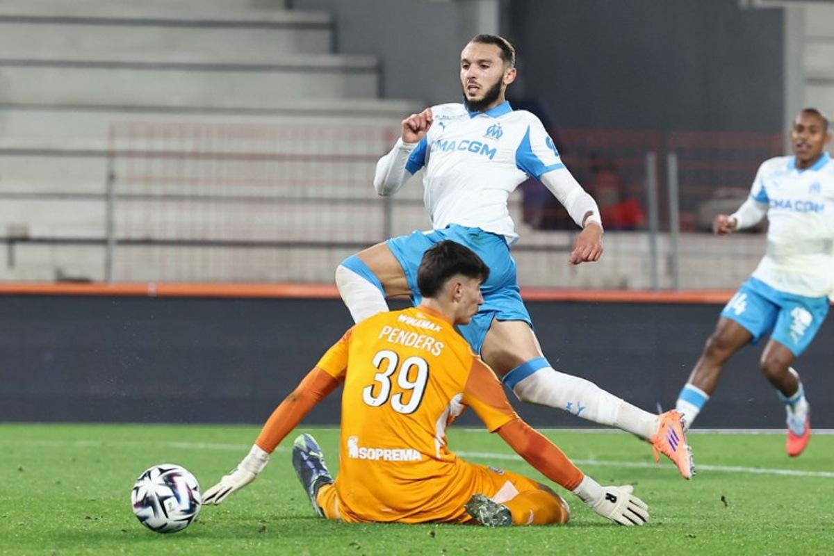 Strasbourg's Belgian goalkeeper #39 Mike Penders (DOWN) fights for the ball with  Marseille's Algerian forward #09 Amine Gouiri during the French L1 football match between RC Strasbourg Alsace and Olympique de Marseille (OM) at the Stade de la Meinau in Strasbourg, eastern France, on September 26, 2025.  Frederick FLORIN / AFP