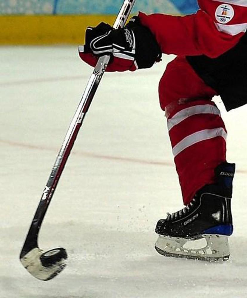 A Canadian player stick handles the puck during the Women's Ice Hockey preliminary game between Switzerland  and Canada at the UBC Thunderbird Arena  during the XXI Winter Olympic Games in Vancouver, Canada on February 15, 2010. AFP PHOTO/Luis ACOSTA