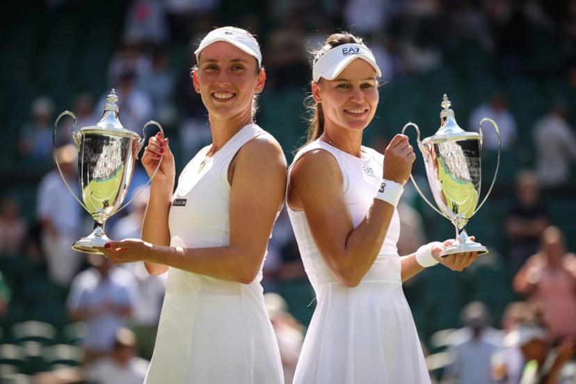 First-placed Russia's Veronika Kudermetova (R) and Belgium's Elise Mertens pose with their trophies after winning against Taiwan's Hsieh Su-wei and Latvia's Jelena Ostapenko at the end of their women's doubles final tennis match on the fourteenth day of the 2025 Wimbledon Championships at The All England Lawn Tennis and Croquet Club in Wimbledon, southwest London, on July 13, 2025.  HENRY NICHOLLS / AFP