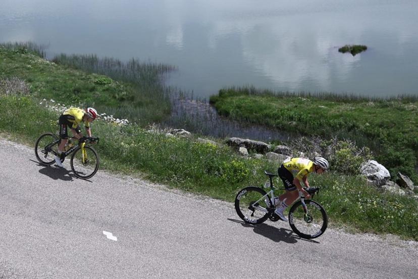 Team Visma - Lease a Bike's Danish rider Jonas Vingegaard (L) and UAE Team Emirates XRG's Slovenian rider Tadej Pogačar wearing the overall leader's yellow jersey cycle near the Col de la Croix de Fer during the 7th stage of the 77th edition of the Criterium du Dauphine cycling race, 131,6 km between Grand-Aigueblanche and Valmeinier, on June 14, 2025.  Anne-Christine POUJOULAT / AFP