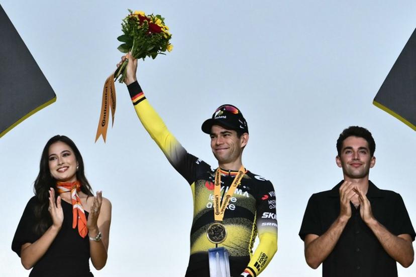 Team Visma - Lease a bike team's Belgian rider Wout van Aert celebrates on the podium after winning the 21st and final stage of the 112th edition of the Tour de France cycling race, 132.3 km between Mantes-la-Ville and Paris Champs-Élysees, on July 27, 2025.  Marco BERTORELLO / AFP