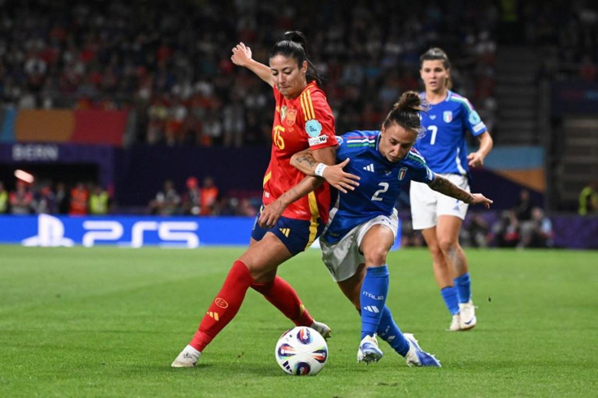 Spain's defender #15 Leila Ouahabi (L) fights for the ball with Italy's defender #02 Elisabetta Oliviero  during the UEFA Women's Euro 2025 Group B football match between Italy and Spain at the Wankdorf Stadium in Bern, on July 11, 2025.  SEBASTIEN BOZON / AFP