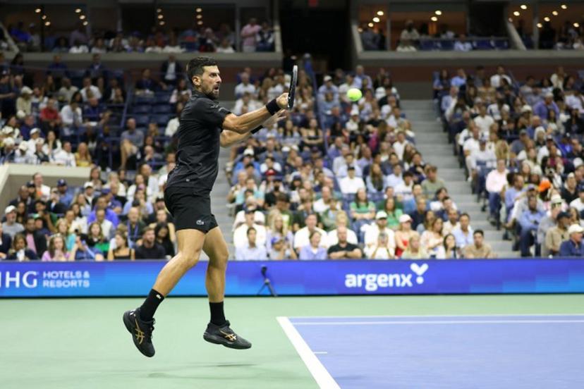 Serbia's Novak Djokovic hits a forehand return to Britain's Cameron Norrie during their men's singles third round match on day six of the US Open tennis tournament at the USTA Billie Jean King National Tennis Center in New York City on August 29, 2025.  CHARLY TRIBALLEAU / AFP