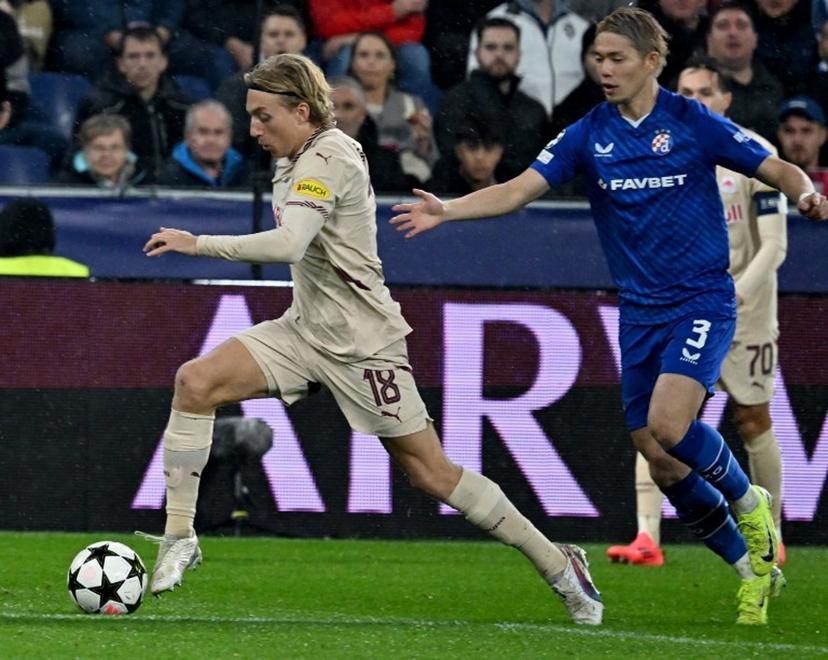 Salzburg's Danish midfielder #18 Mads Bidstrup (L) and Dinamo Zagreb's Japanese defender #03 Takuya Ogiwara vie for the ball during the UEFA Champions League football match between Salzburg and GNK Dinamo Zagreb in Salzburg, Austria on October 23, 2024.   BARBARA GINDL / APA / AFP