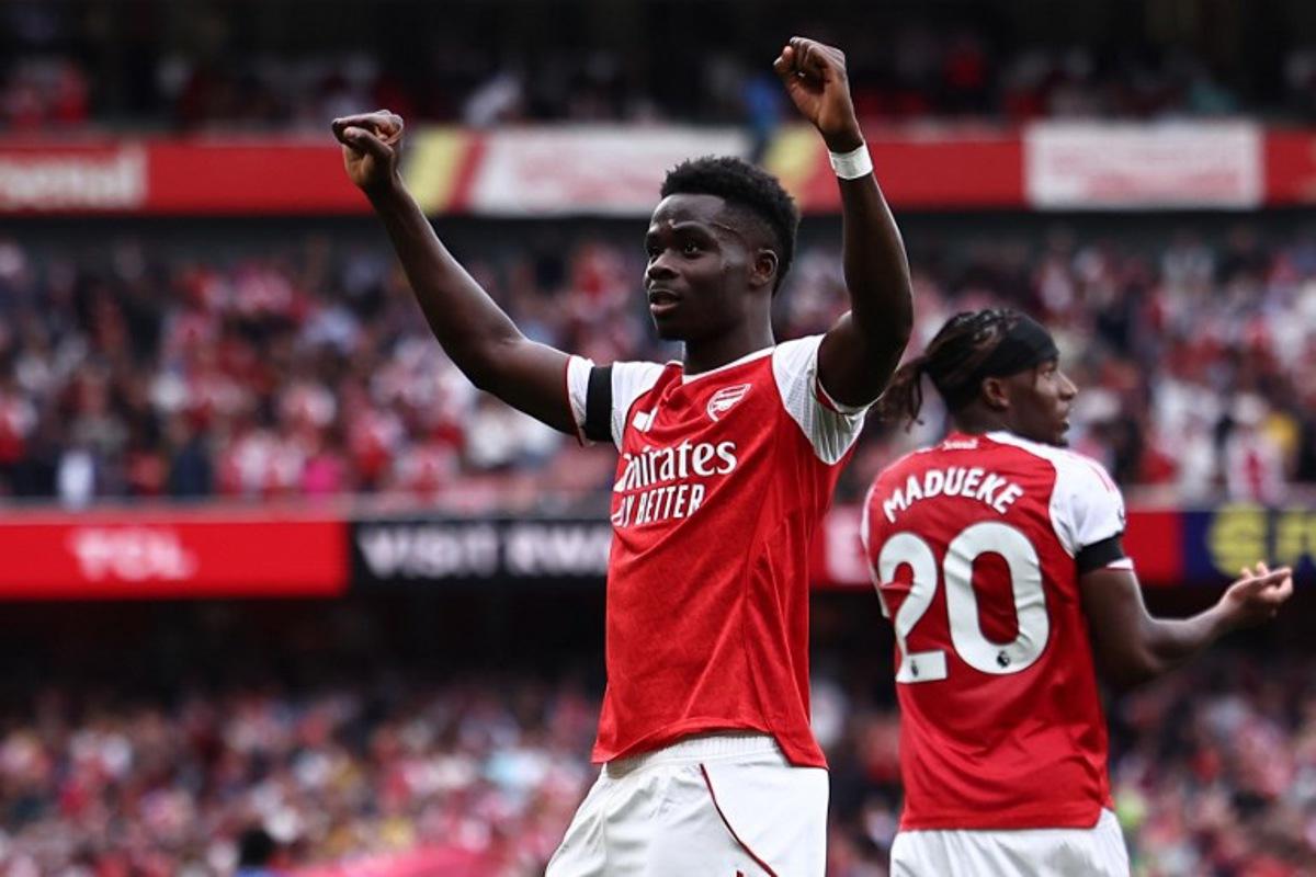 Arsenal's English midfielder #07 Bukayo Saka celebrates scoring the team's second goal during the English Premier League football match between Arsenal and Leeds United at the Emirates Stadium in London on August 23, 2025.   HENRY NICHOLLS / AFP