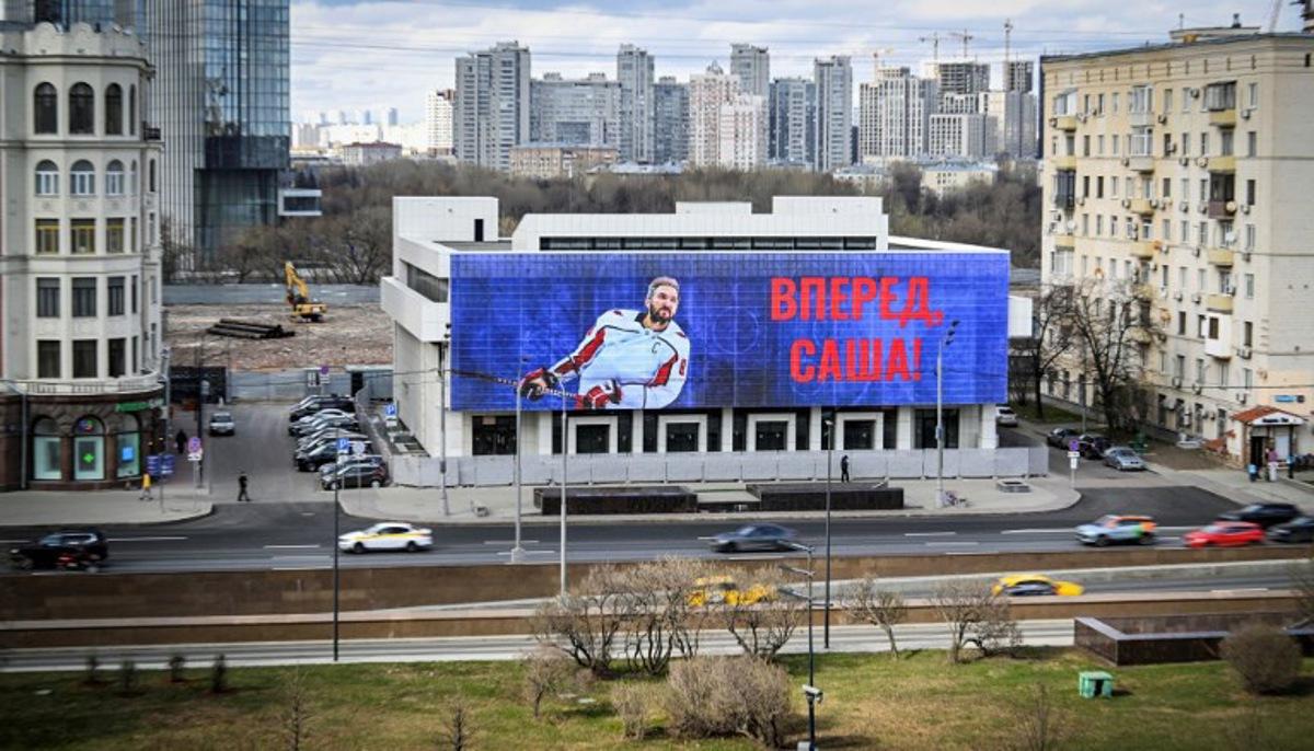 (FILES) This photograph shows an advertising screen displaying an image of Russian ice hockey star Alexander Ovechkin, reading "Alex! Go Ahead!" in Moscow, on April 5, 2025. Washington Capitals star Alex Ovechkin scored goal No. 895 on April 6, 2025, passing Hall of Famer Wayne Gretzky to become the NHL's all-time goal scoring leader. Alexander NEMENOV / AFP