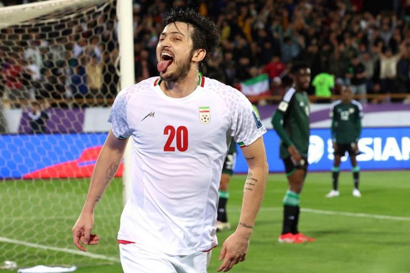 Iran's forward #20 Sardar Azmoun celebrates after scoring their first goal during the FIFA World Cup 2026 Asia zone qualifiers group A football match between Iran and the United Arab Emirates at the Azadi Sports Complex in Tehran on March 20, 2025.  AFP