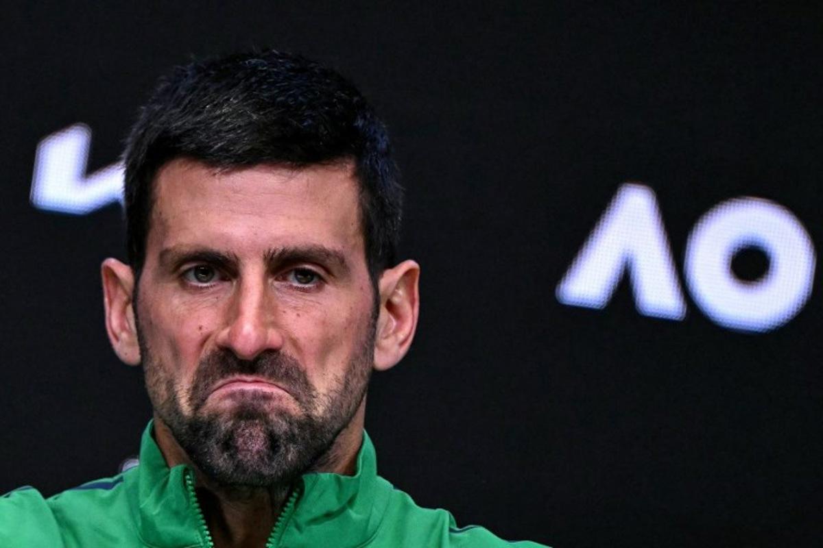 Serbia's Novak Djokovic reacts during a press conference after his defeat against Spain's Carlos Alcaraz in their men's singles final match on day fifteen of the Australian Open tennis tournament in Melbourne on February 1, 2026.  WILLIAM WEST / AFP