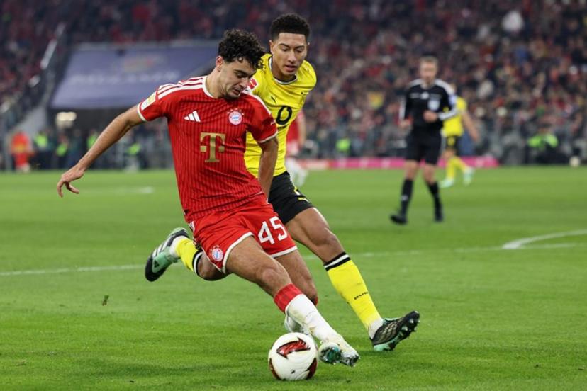 Bayern Munich's German midfielder #45 Aleksandar Pavlovic and Dortmund's English midfielder #07 Jobe Bellingham vie for the ball during the German first division Bundesliga football match between FC Bayern Munich and BVB Borussia Dortmund in Munich, southern Germany, on October 31, 2026.  Alexandra BEIER / AFP