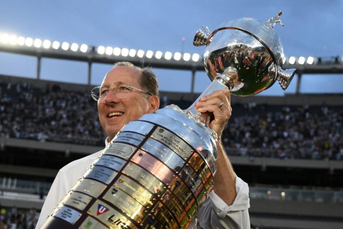 US businessman and owner of Botafogo's SAF, John Textor celebrates with the trophy after winning the Copa Libertadores final football match between Brazilian teams Atletico Mineiro and Botafogo at the Mas Monumental Stadium in Buenos Aires on November 30, 2024.  Luis ROBAYO / AFP