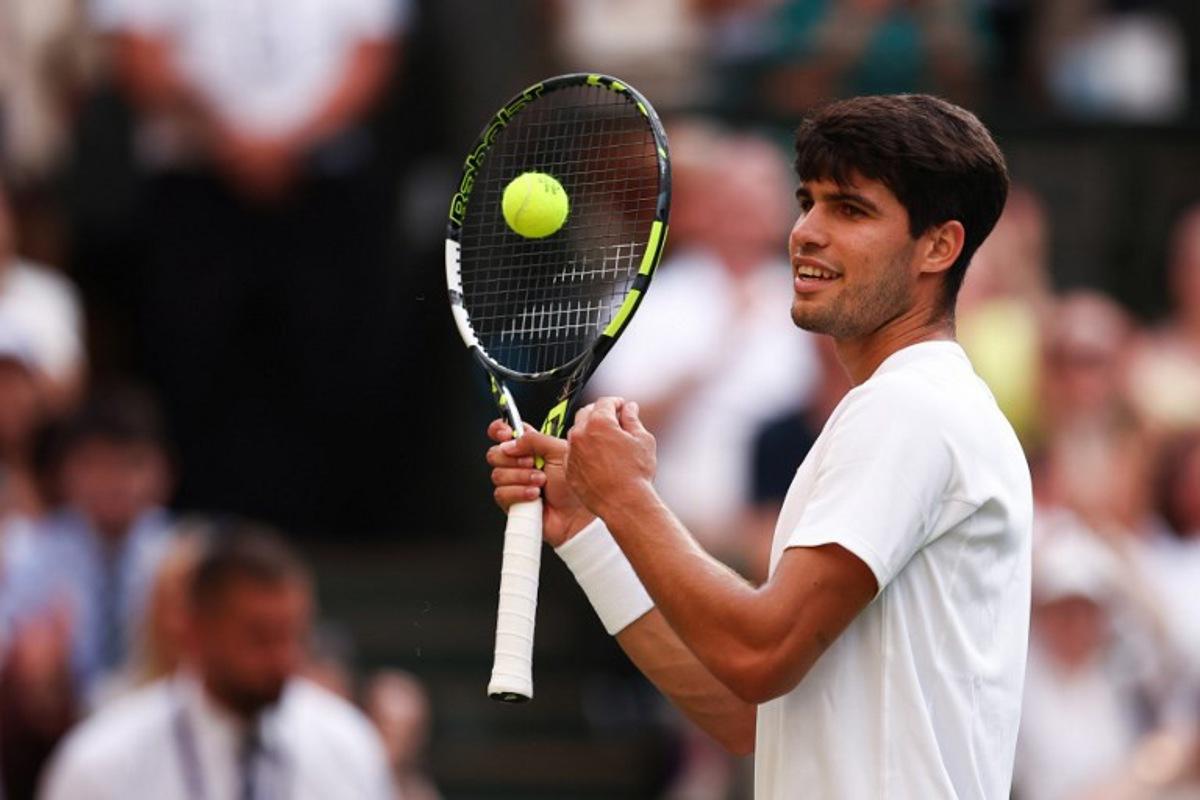 Spain's Carlos Alcaraz reacts as he plays against Italy's Jannik Sinner during their men's singles final tennis match on the fourteenth day of the 2025 Wimbledon Championships at The All England Lawn Tennis and Croquet Club in Wimbledon, southwest London, on July 13, 2025.  HENRY NICHOLLS / AFP